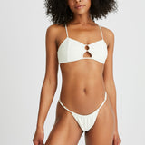 Woman wears padded white bikini top with matching bikini bottoms