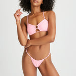 Woman wears padded pink bikini top with matching bikini bottoms