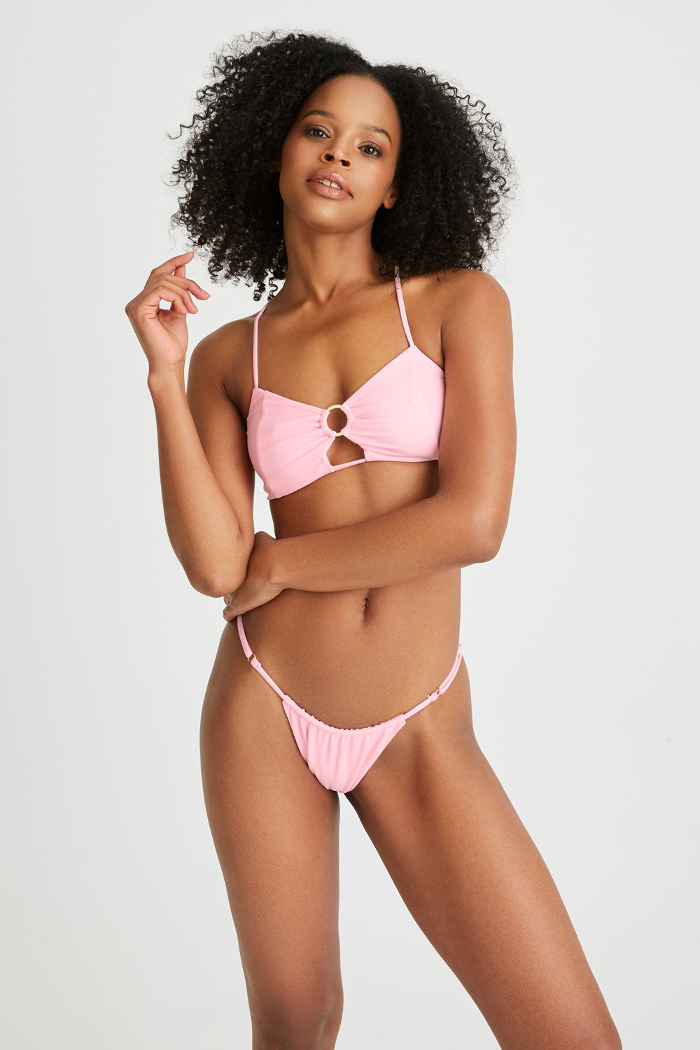Woman wears padded pink bikini top with matching bikini bottoms